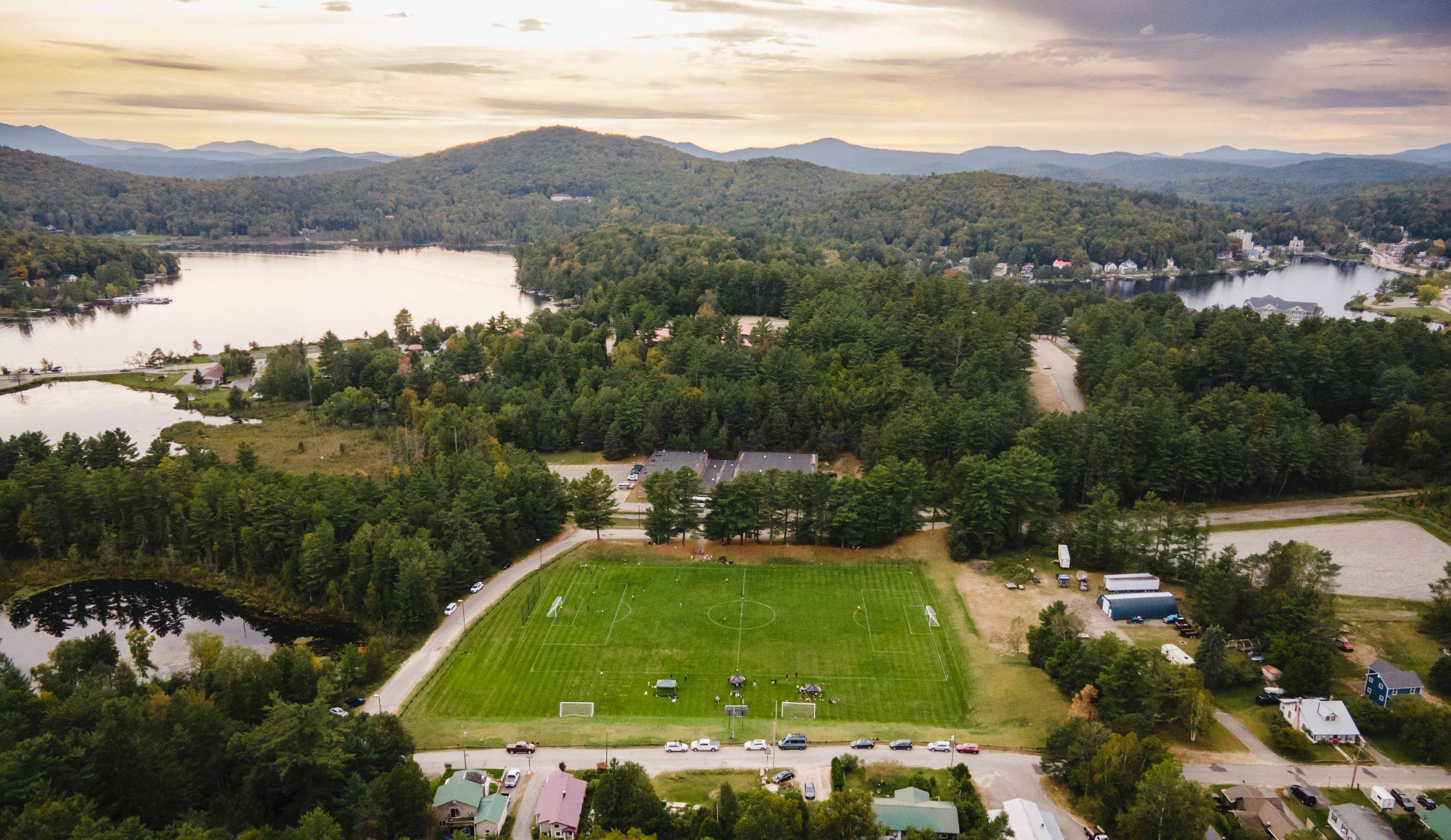 The college's soccer field, against a back drop of lakes and mountains