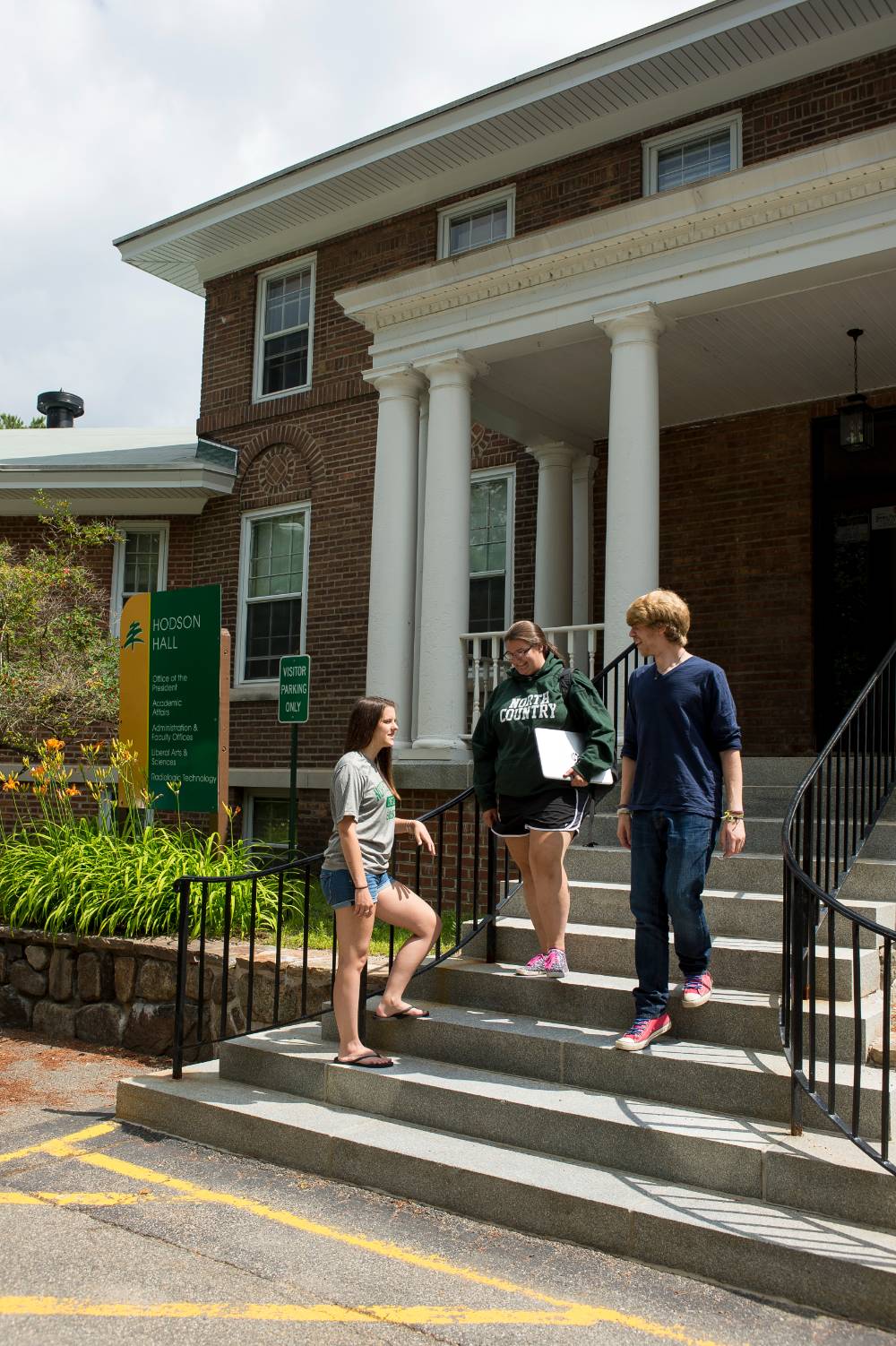 Students stand outside Hodson Hall on the Saranac Lake campus.