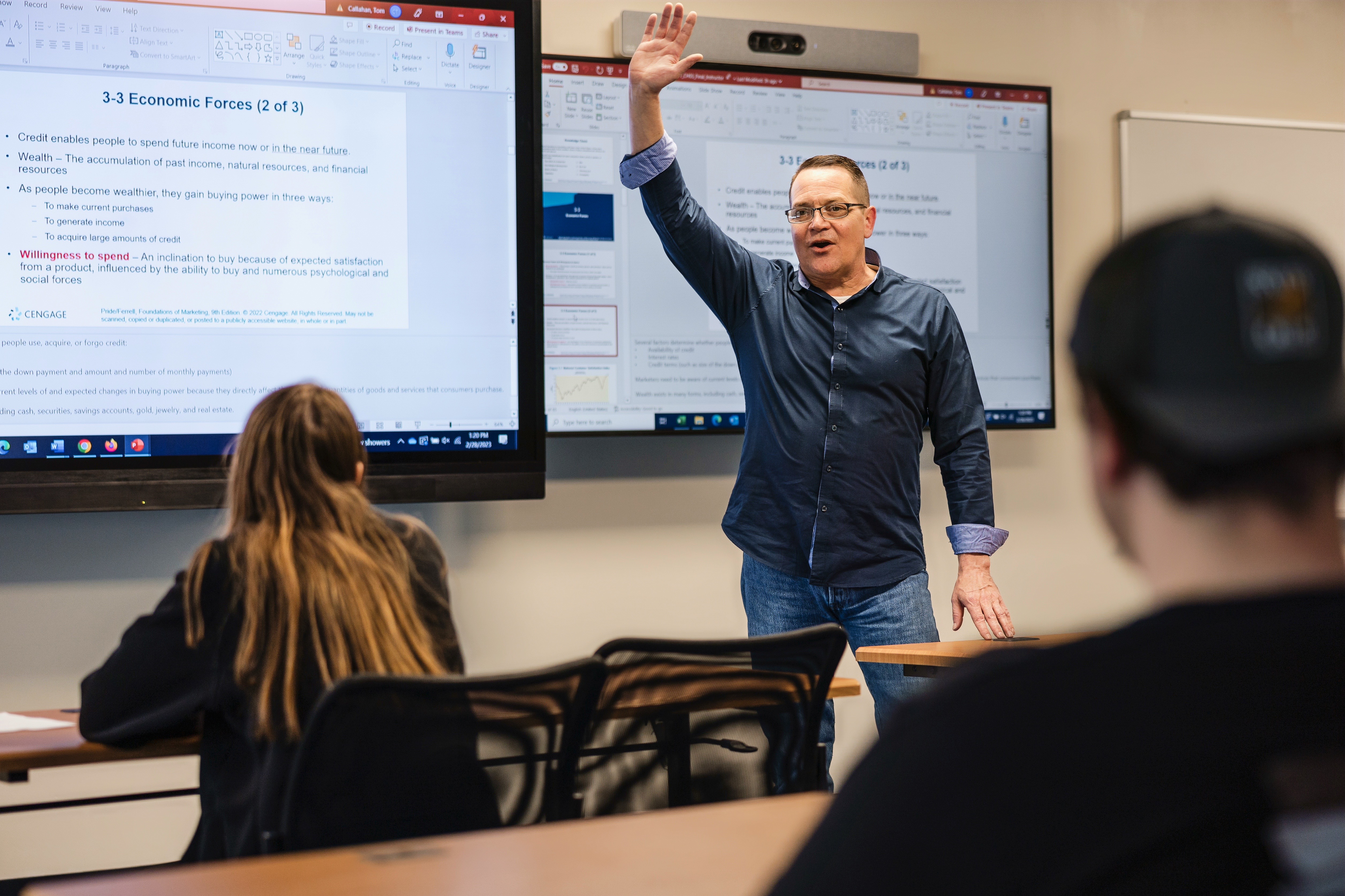 Students listen to an instructor in the college's Business Program