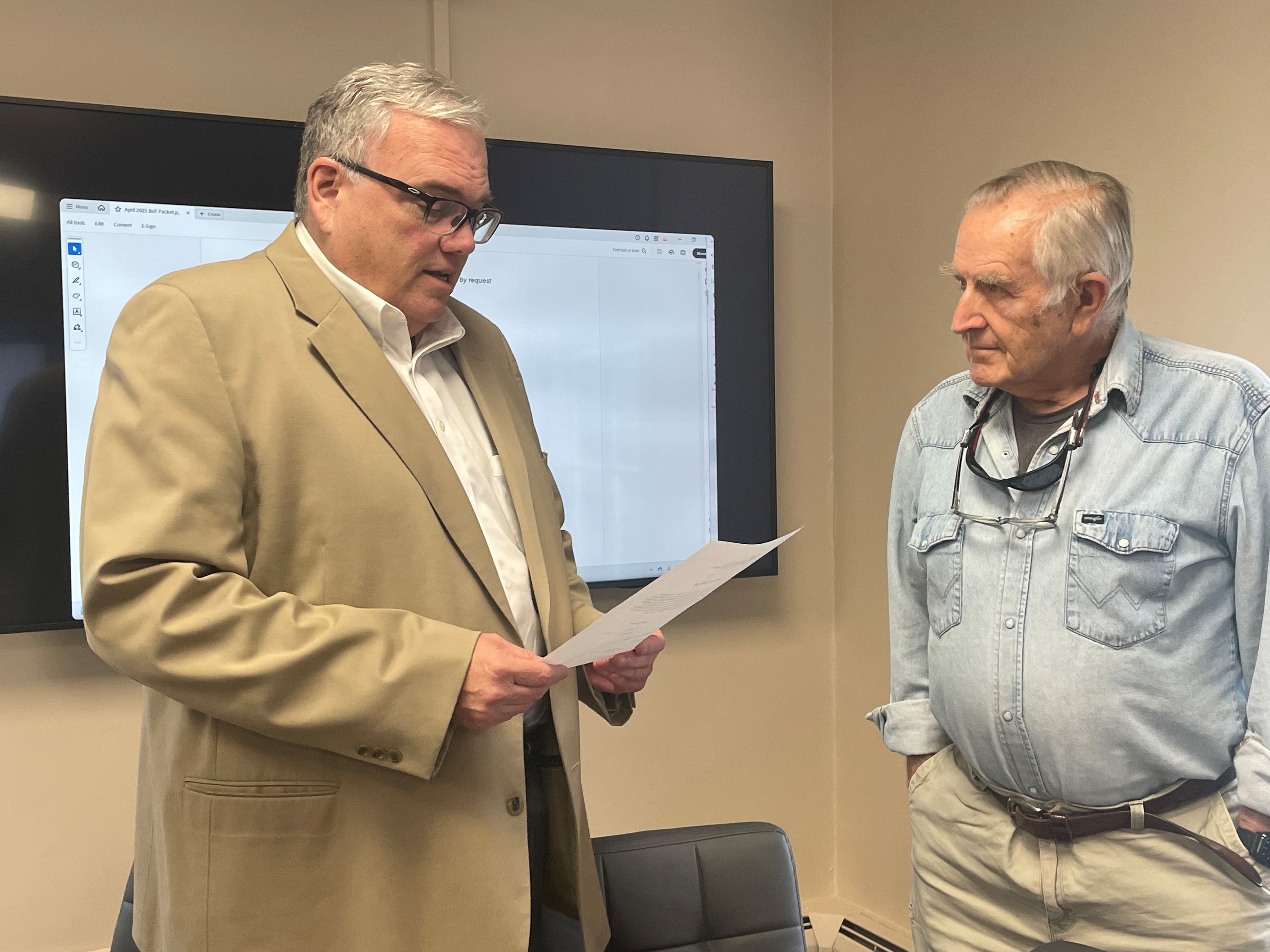 David McNally stands and reads from a piece of paper