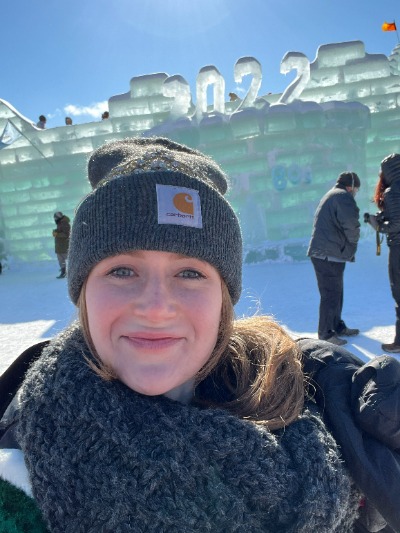 Jessica Kemp, NCCC student and Winter Carnival princess, smiles as she stands in front of the Ice Palace.