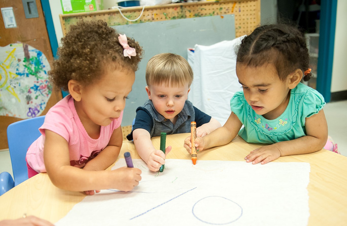 Children drawa at a table at a preschool