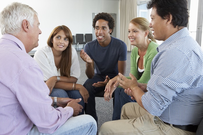 Students talk in a group with an instructor