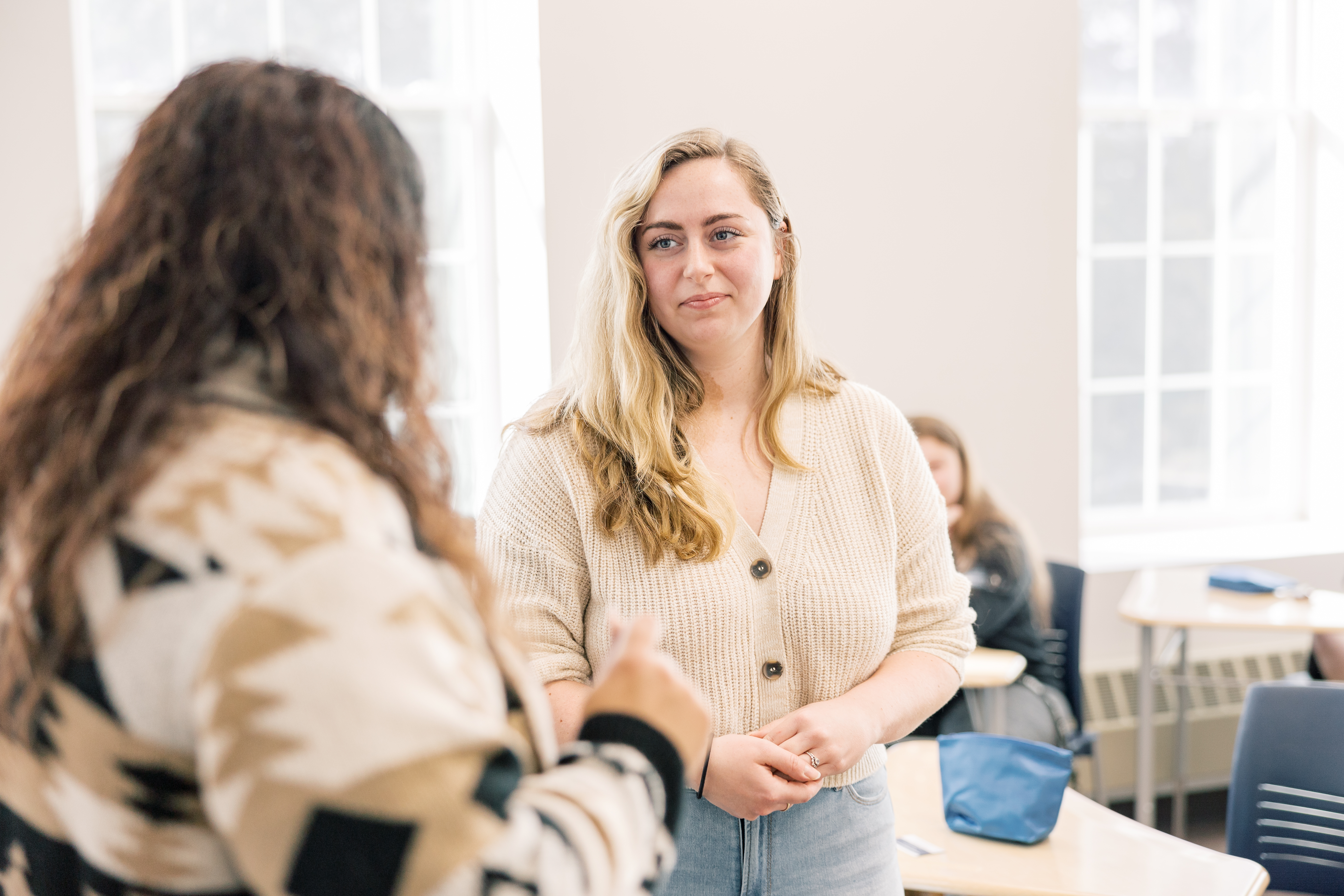 A student works with an instructor in a classroom