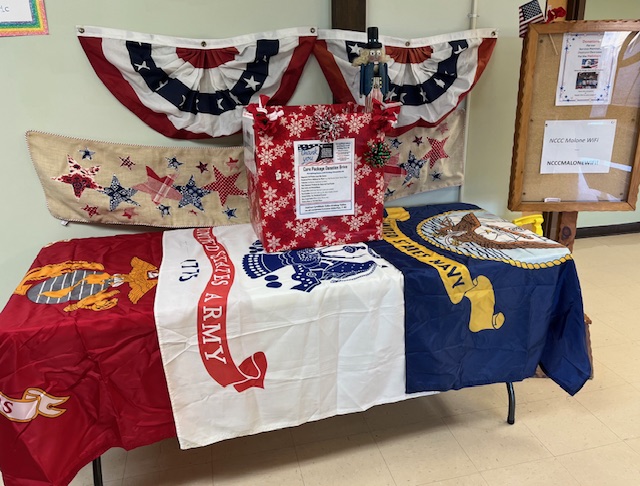 A table with flags on it for donating items to veterans