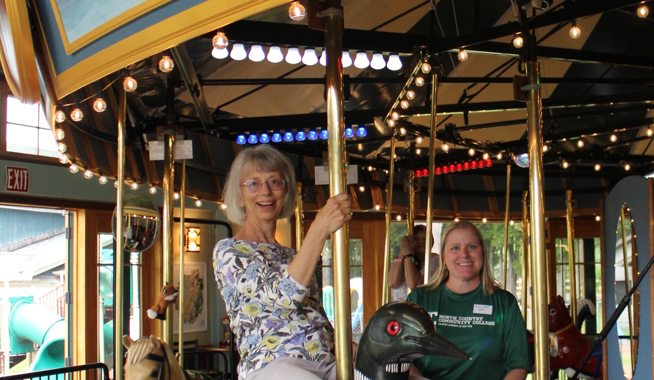 A woman rides a carousel