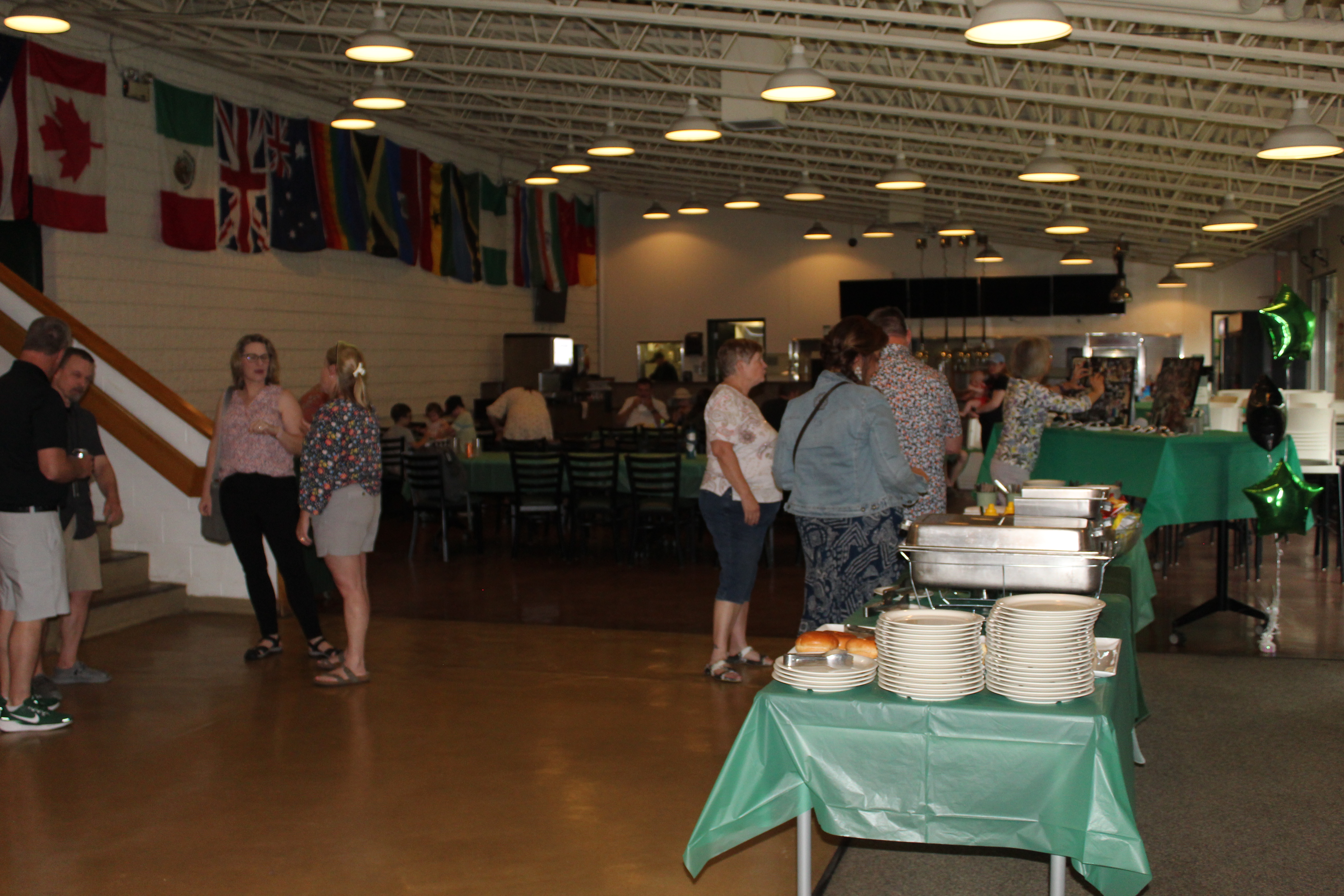 People stand inside the college connector talking