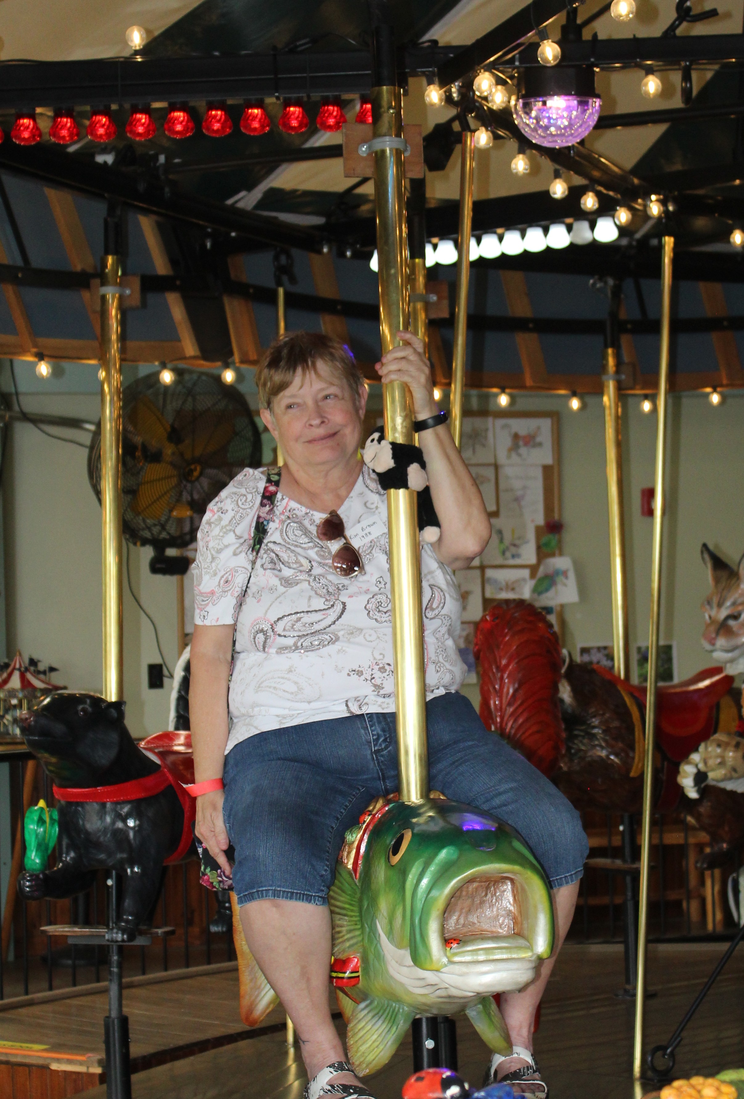 a woman rides a carousel
