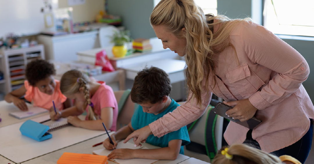 A teacher instructs students in a classroom