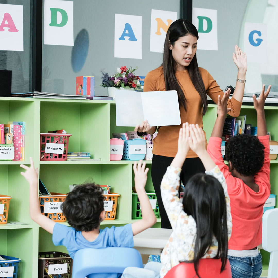 A teacher leads a lesson in front of her students