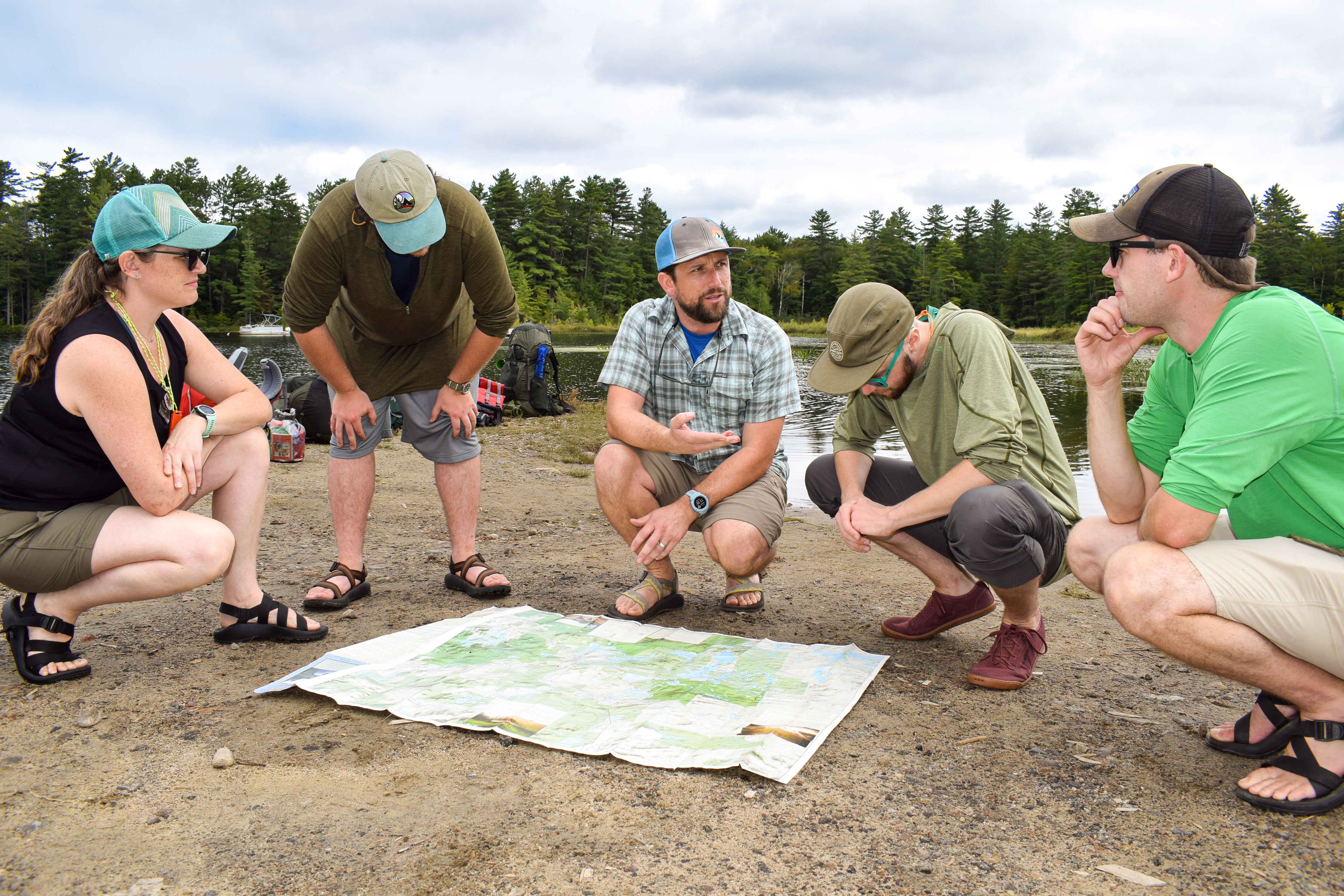 Students in the Wilderness Recreation Leadership program listen to an instructor as they look over a map