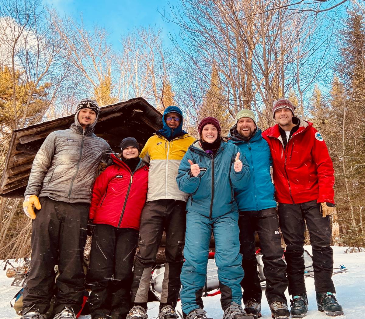 Students stand in a group outside in winter clothing